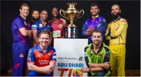 ক্রিকেটাররা টি-১০ লিগের ট্রফির পাশে দাঁড়িয়ে হাসছে।. Channel i News - চ্যানেল আই নিউজ