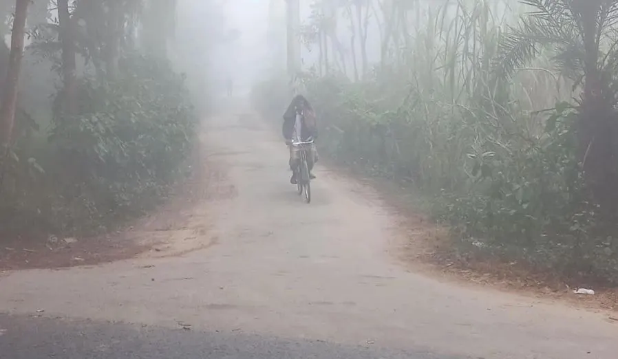 ধূসর সকালে ধূসর রাস্তায় সাইকেল চালাচ্ছে একজন ব্যক্তি. Channel i News - চ্যানেল আই নিউজ