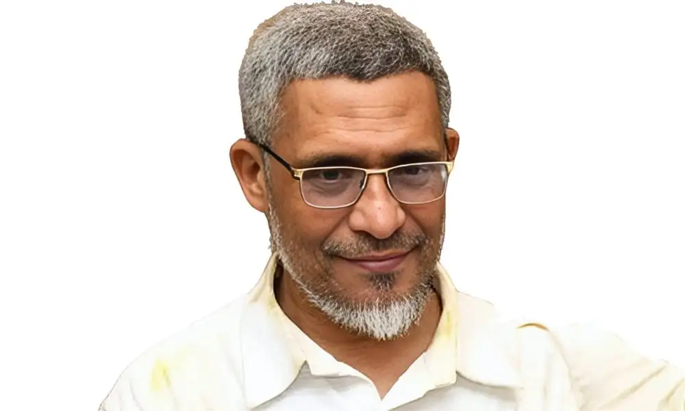 বাংলাদেশি ব্যক্তি, চশমা পরা, হালকা গেঞ্জি পরিহিত, হাসিমুখে. Channel i News - চ্যানেল আই নিউজ