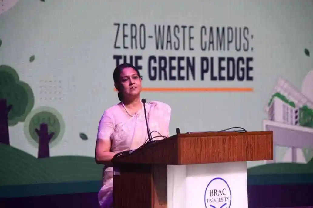Woman speaking at a podium during zero-waste campus event. Channel i News - চ্যানেল আই নিউজ
