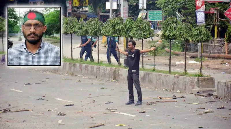 বিক্ষোভকারীর প্রতিবাদে রাস্তায় দাঁড়িয়ে আছেন একজন যুবক. Channel i News - চ্যানেল আই নিউজ