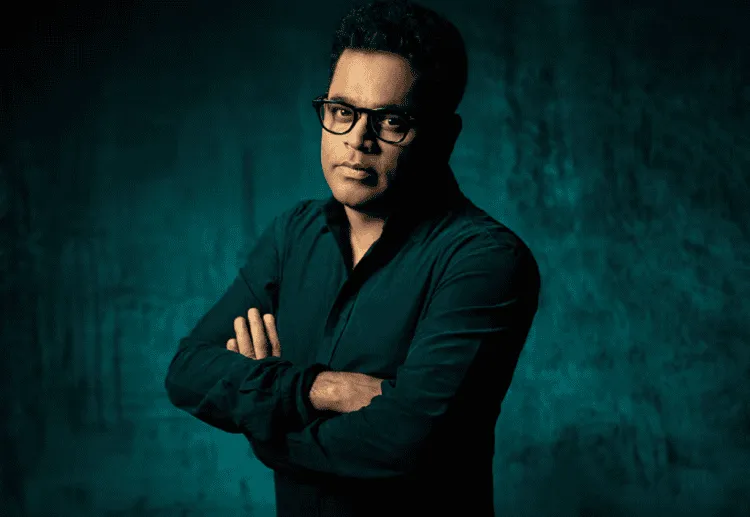 এ আর রহমানের ছবি, তিনি গম্ভীর মুখাবয়ব ও কালো পোশাক পরেছেন. Channel i News - চ্যানেল আই নিউজ