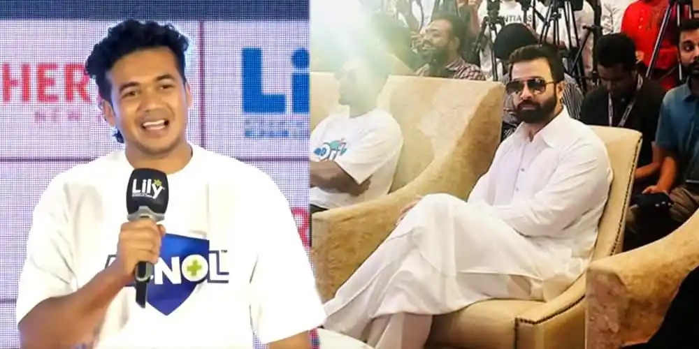 তাসকিনের ছবি, তিনি সাদা পোশাক পরিহিত, দর্শকদের মাঝে বসে আছেন।. Channel i News - চ্যানেল আই নিউজ
