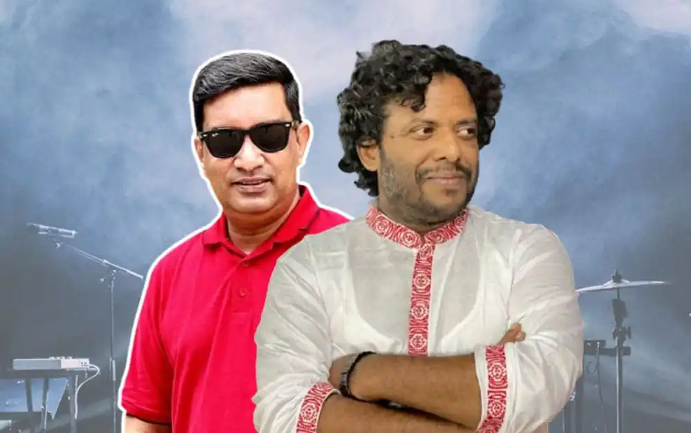 দুই বন্ধু একসঙ্গে দাঁড়িয়ে, পেছনে ব্যাকড্রপে মিউজিক্যাল ইন্সট্রুমেন্টস. Channel i News - চ্যানেল আই নিউজ
