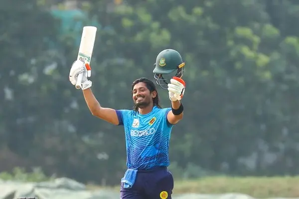 বাংলাদেশ ক্রিকেটার বিজয় উদযাপন করছেন, হাতে ব্যাট ও হেলমেট. Channel i News - চ্যানেল আই নিউজ