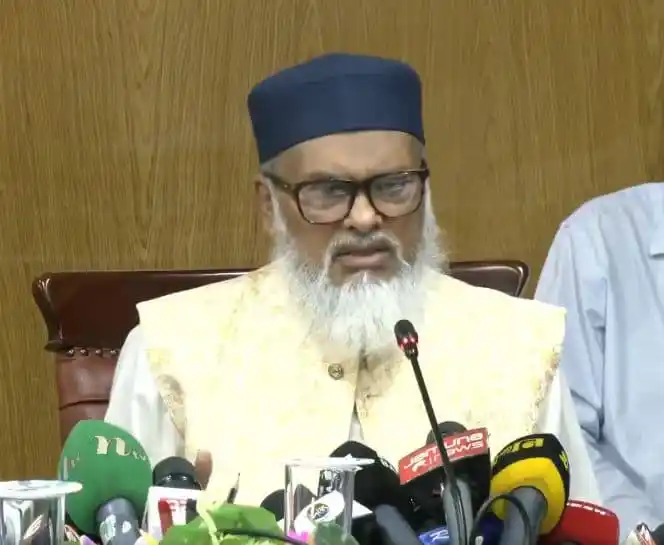 Bangladeshi religious leader speaking at a press conference with microphones. Channel i News - চ্যানেল আই নিউজ