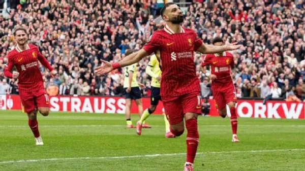Liverpool footballer celebrating a goal in a packed stadium. Channel i News - চ্যানেল আই নিউজ