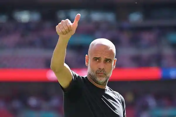 Pep Guardiola giving a thumbs-up during a football match. Channel i News - চ্যানেল আই নিউজ
