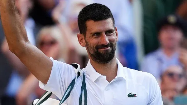 Wimbledon tennis player celebrating victory with a smile and raised arm. Channel i News - চ্যানেল আই নিউজ