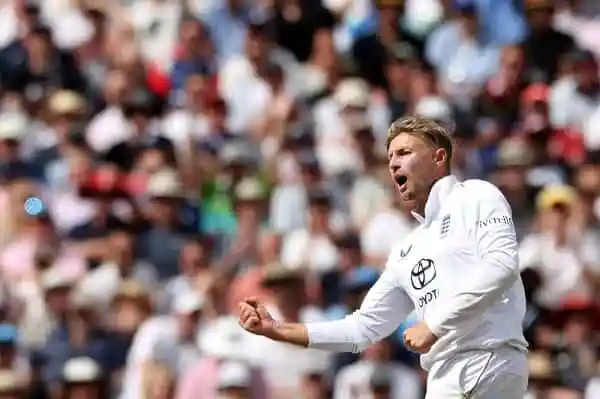Cricketer celebrating a successful catch in a match with a large crowd in the background. Channel i News - চ্যানেল আই নিউজ