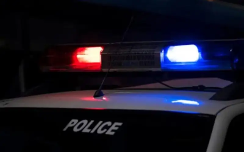 Police car with flashing red and blue lights at night. Channel i News - চ্যানেল আই নিউজ