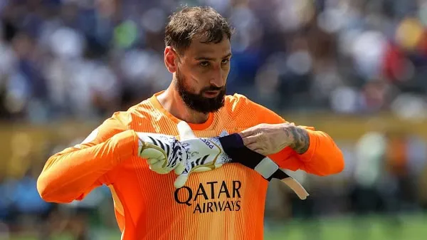 Goalkeeper in orange jersey adjusting gloves during match. Channel i News - চ্যানেল আই নিউজ