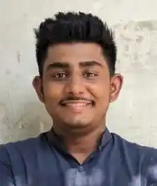 প্রফুল্ল যুবক ব্যক্তি হাসিমুখে, কালো চুল ও নীল শার্ট পরা. Channel i News - চ্যানেল আই নিউজ