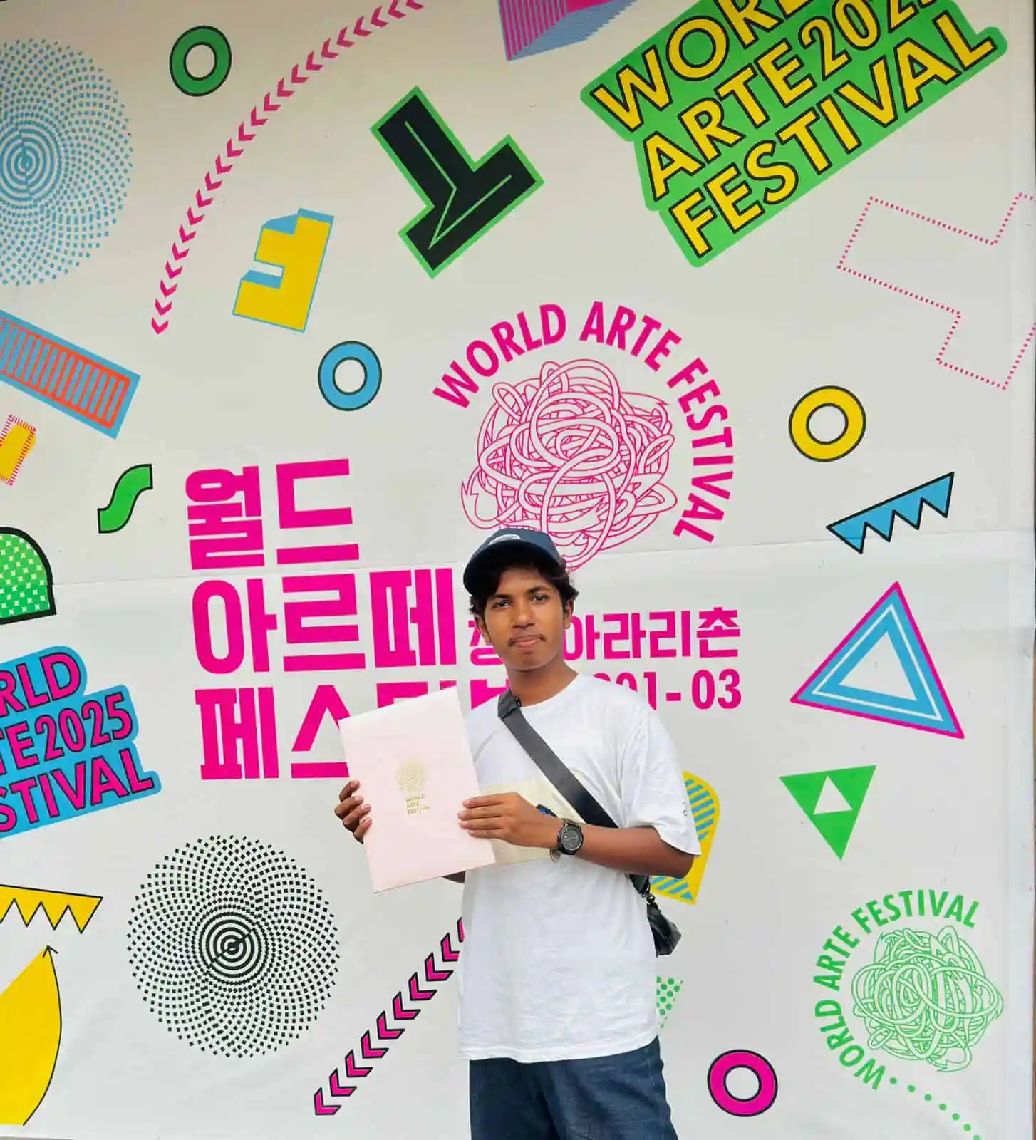 Young man holding a certificate at World Art Festival in Korea. Channel i News - চ্যানেল আই নিউজ