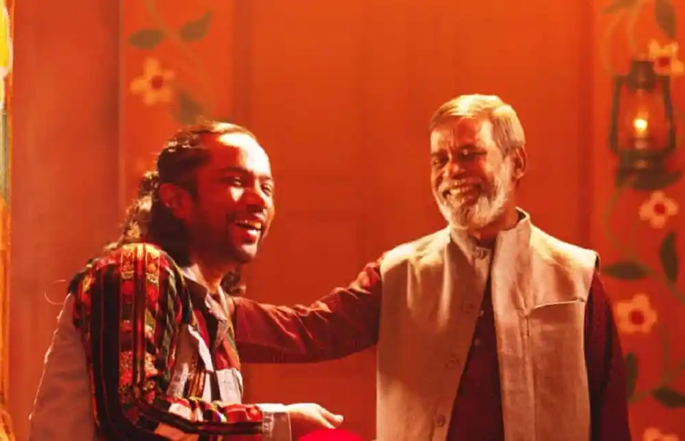 দুই ব্যক্তি হাসিমুখে একে অপরের সাথে শুভেচ্ছা বিনিময় করছেন।. Channel i News - চ্যানেল আই নিউজ