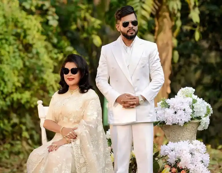 দম্পতি সাদা পোশাক পরা, গাছে ঘেরা সুন্দর প্রকৃতির মধ্যে ছবি।. Channel i News - চ্যানেল আই নিউজ