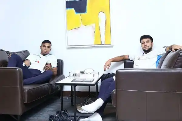 দুই যুবক বসে আছেন আরামদায়ক সোফায়, একটি টেবিলের পাশে।. Channel i News - চ্যানেল আই নিউজ