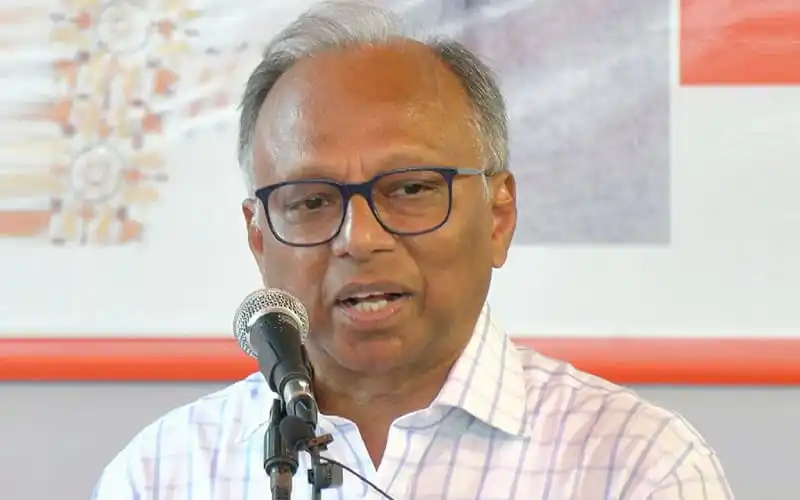 Bangladeshi politician speaking at a press conference with a microphone. Channel i News - চ্যানেল আই নিউজ
