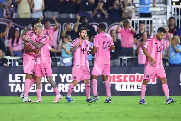 FC Barcelona players celebrate a goal in pink kits during a match. Channel i News - চ্যানেল আই নিউজ
