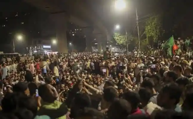 Huge crowd gathered at night under a bridge in Bangladesh. Channel i News - চ্যানেল আই নিউজ