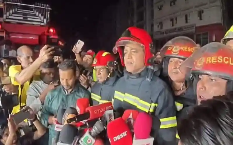 Firefighters and officials at the scene of Mipur's community center fire. Channel i News - চ্যানেল আই নিউজ