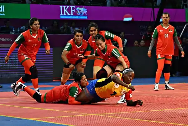 Bangladeshi women's kabaddi team in action during a match at a sports event. Channel i News - চ্যানেল আই নিউজ