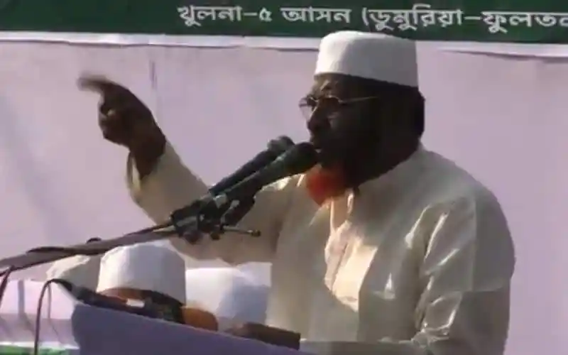 নেতা বক্তৃতা দিচ্ছেন, পেছনে বাংলার পতাকা ও স্লোগান।. Channel i News - চ্যানেল আই নিউজ