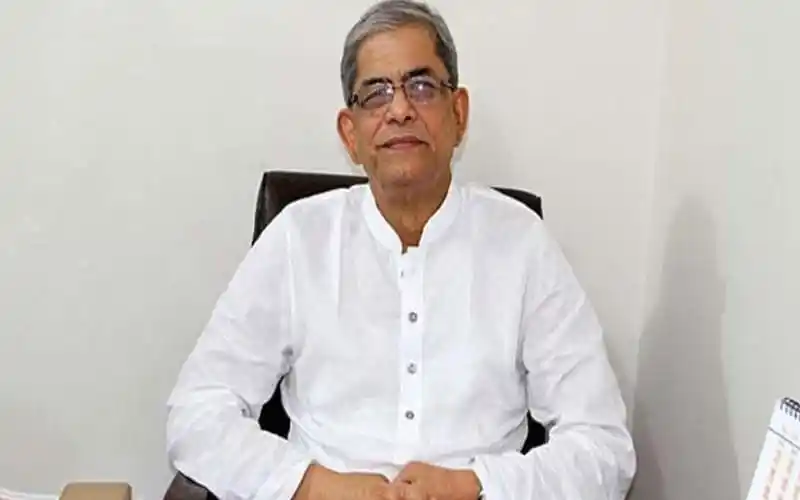 বাংলাদেশের একজন রাজনীতিবিদ বসে আছেন, পরিপাটি পোশাক পরা. Channel i News - চ্যানেল আই নিউজ