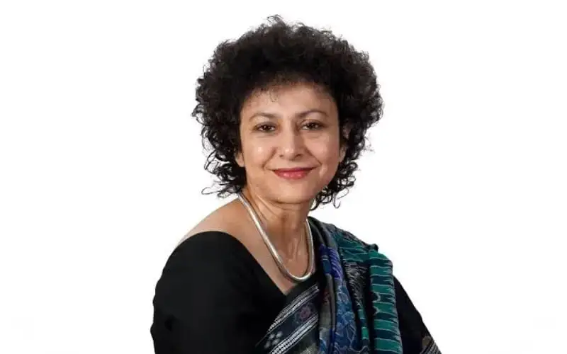 Portrait of a woman with curly hair wearing a black dress and traditional Bengali saree. Channel i News - চ্যানেল আই নিউজ