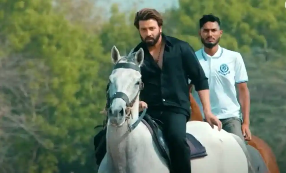 শাকিব খান ও অন্য একজন অভিনেতা ঘোড়ার saddle এ বসে ছবি তুলছেন. Channel i News - চ্যানেল আই নিউজ