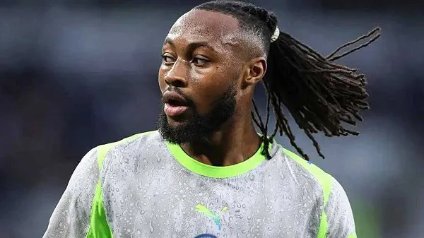 Football player with dreadlocks in a gray and neon green jersey. Channel i News - চ্যানেল আই নিউজ