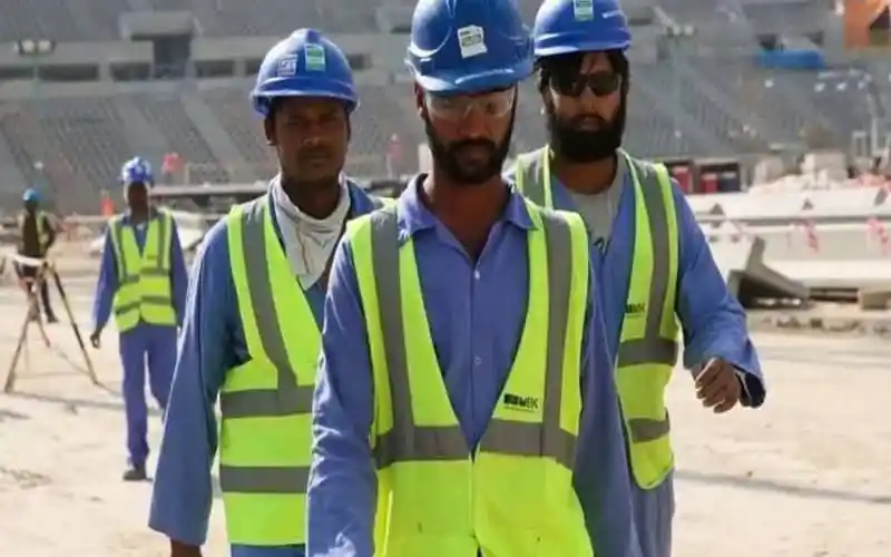 Construction workers wearing safety vests and helmets at a building site in Bangladesh. Channel i News - চ্যানেল আই নিউজ
