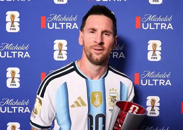 Lionel Messi in Argentina jersey holding FIFA World Cup trophy at press event. Channel i News - চ্যানেল আই নিউজ