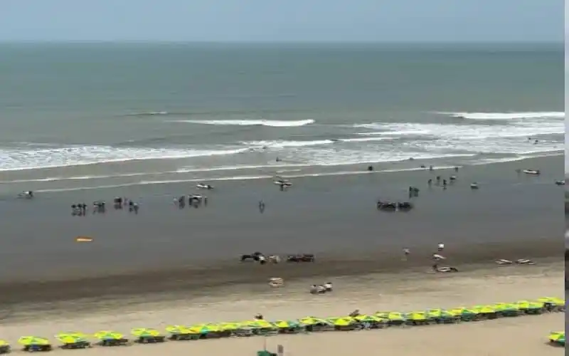 Cox's Bazar beach with parked vehicles and distant waves. Channel i News - চ্যানেল আই নিউজ