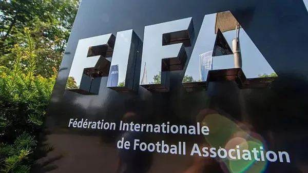 FIFA logo on a black background with green trees in the background. Channel i News - চ্যানেল আই নিউজ