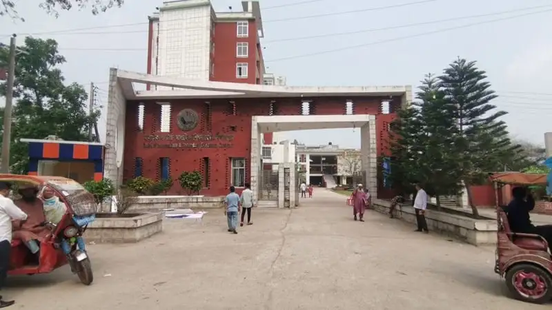 দিনাজপুরের একটি স্কুলের প্রবেশদ্বার, ছাত্র-শিক্ষক ও যানবাহন দেখা যাচ্ছে।. Channel i News - চ্যানেল আই নিউজ