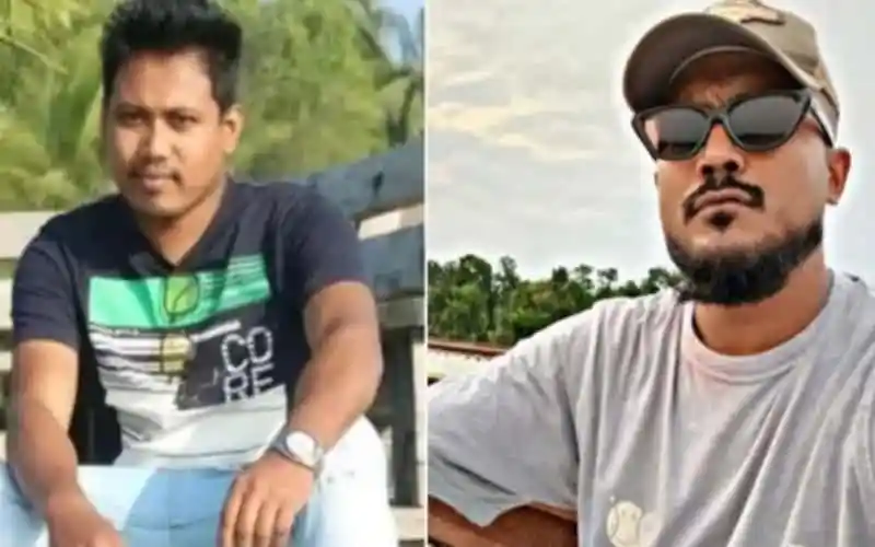 Two men outdoors, one wearing a black T-shirt and the other in a gray T-shirt with sunglasses. Channel i News - চ্যানেল আই নিউজ