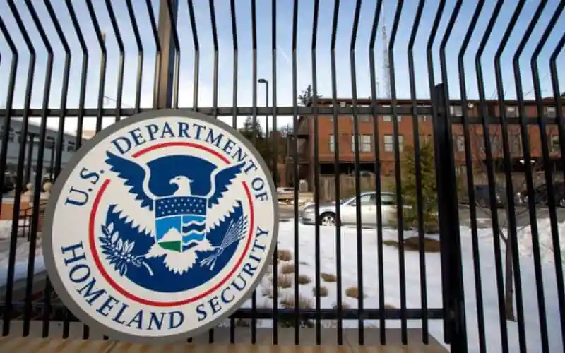 U.S. Department of Homeland Security logo on gate with snow-covered ground. Channel i News - চ্যানেল আই নিউজ