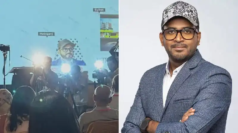 বাংলাদেশি সাংবাদিকের পোর্ট্রেট, তিনি কোট ও ক্যাপ পরেছেন. Channel i News - চ্যানেল আই নিউজ
