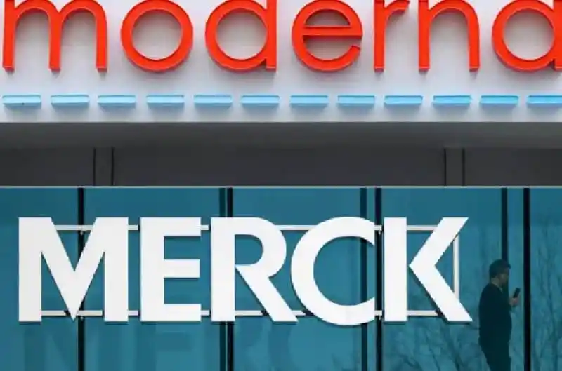 Merck logo in front of a modern building with 'modern' sign above. Channel i News - চ্যানেল আই নিউজ