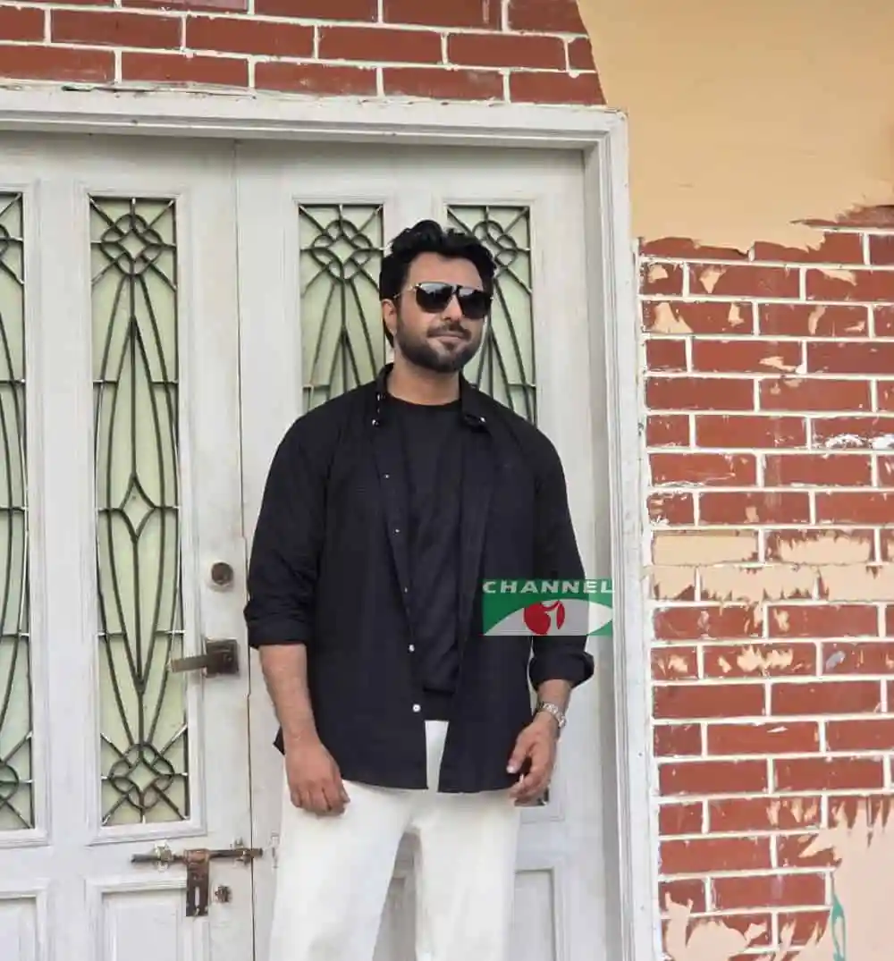 বাংলাদেশি যুবক সেলফি, কালো পোশাক ও সানগ্লাসে, পেছনে ইটের দেয়াল. Channel i News - চ্যানেল আই নিউজ