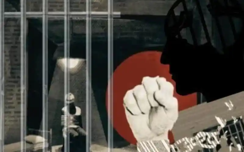 শিল্পীসুলভ silhouette with a guitar and a raised fist, symbolizing protest or activism. Channel i News - চ্যানেল আই নিউজ