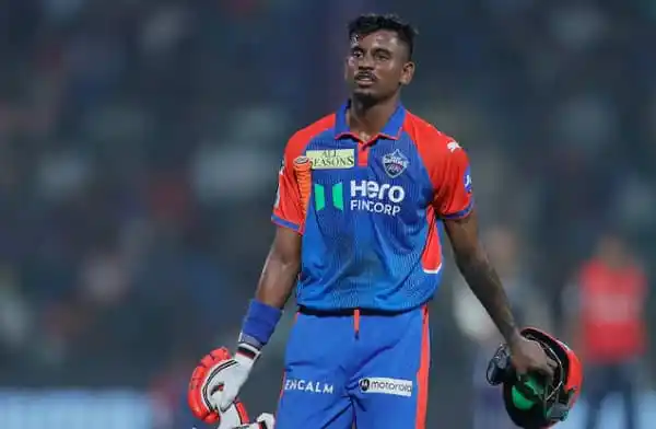 ভারতীয় ক্রিকেটার শিবম দুবে মাঠে দাঁড়িয়ে আছেন, ক্যাপ ও গ্লাভস হাতে. Channel i News - চ্যানেল আই নিউজ