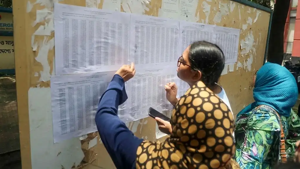 Students checking exam results posted on a notice board in Bangladesh. Channel i News - চ্যানেল আই নিউজ