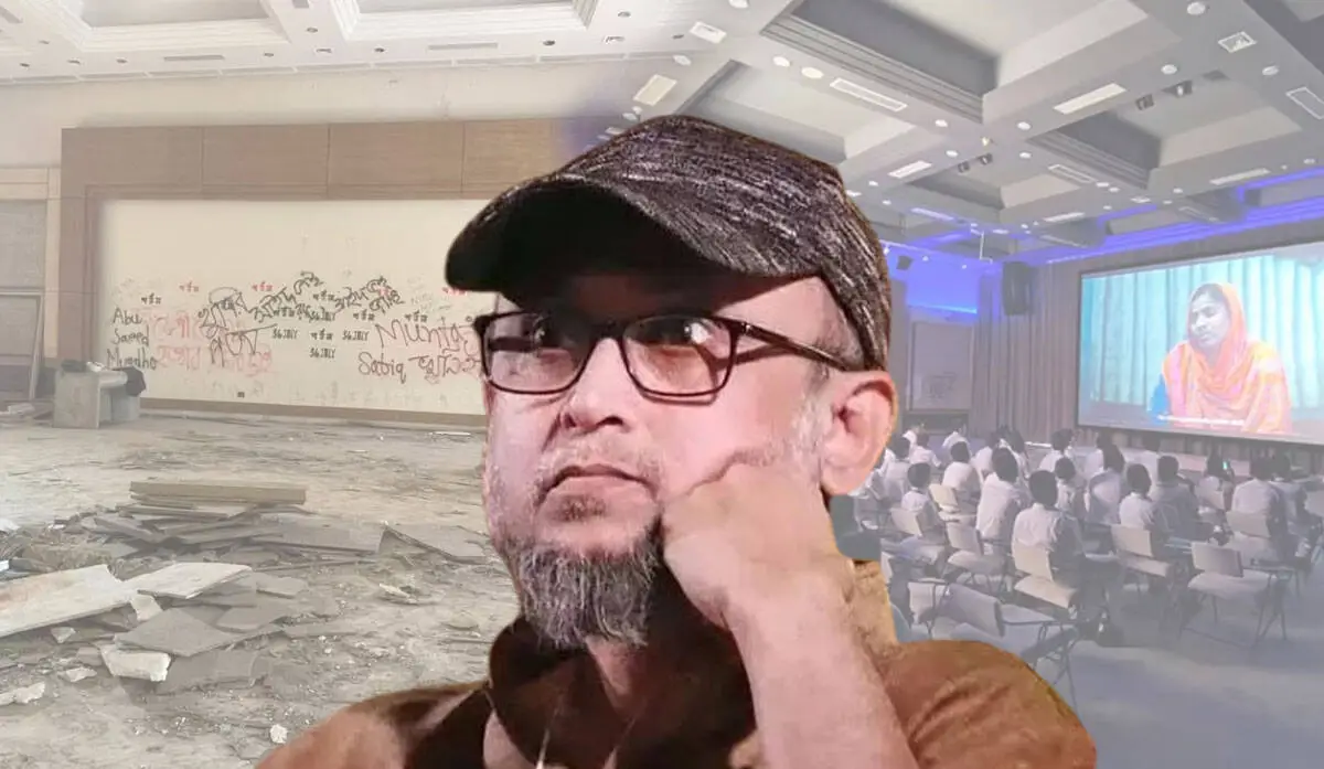 একজন ব্যক্তি ভিডিও কনফারেন্সে অংশ নিচ্ছেন, পেছনে দর্শকদের সমাবেশ. Channel i News - চ্যানেল আই নিউজ